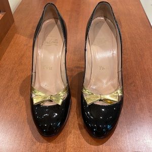 Christian Louboutin black pumps with gold bow